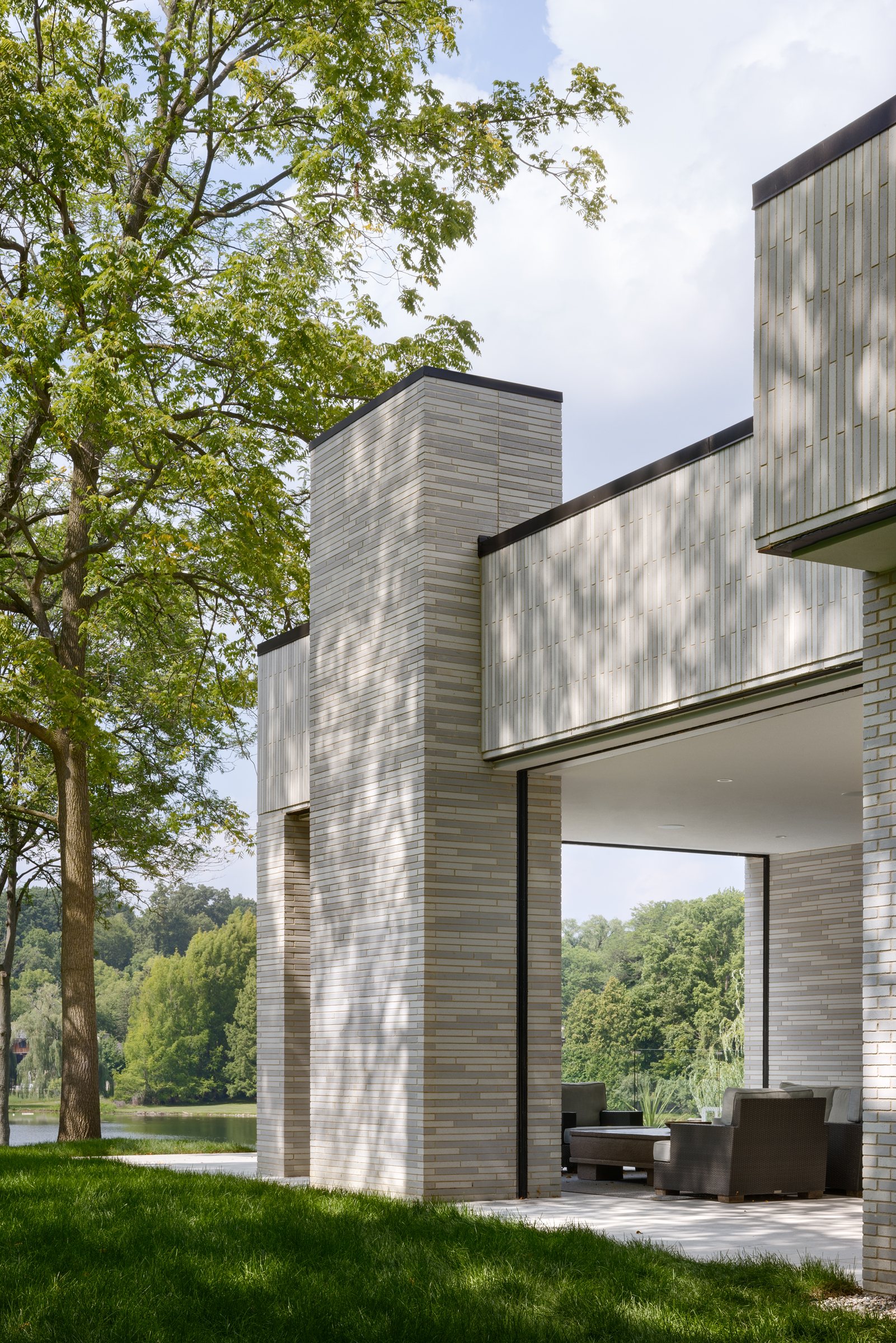 Brick fin wall and overhang framing the lake beyond