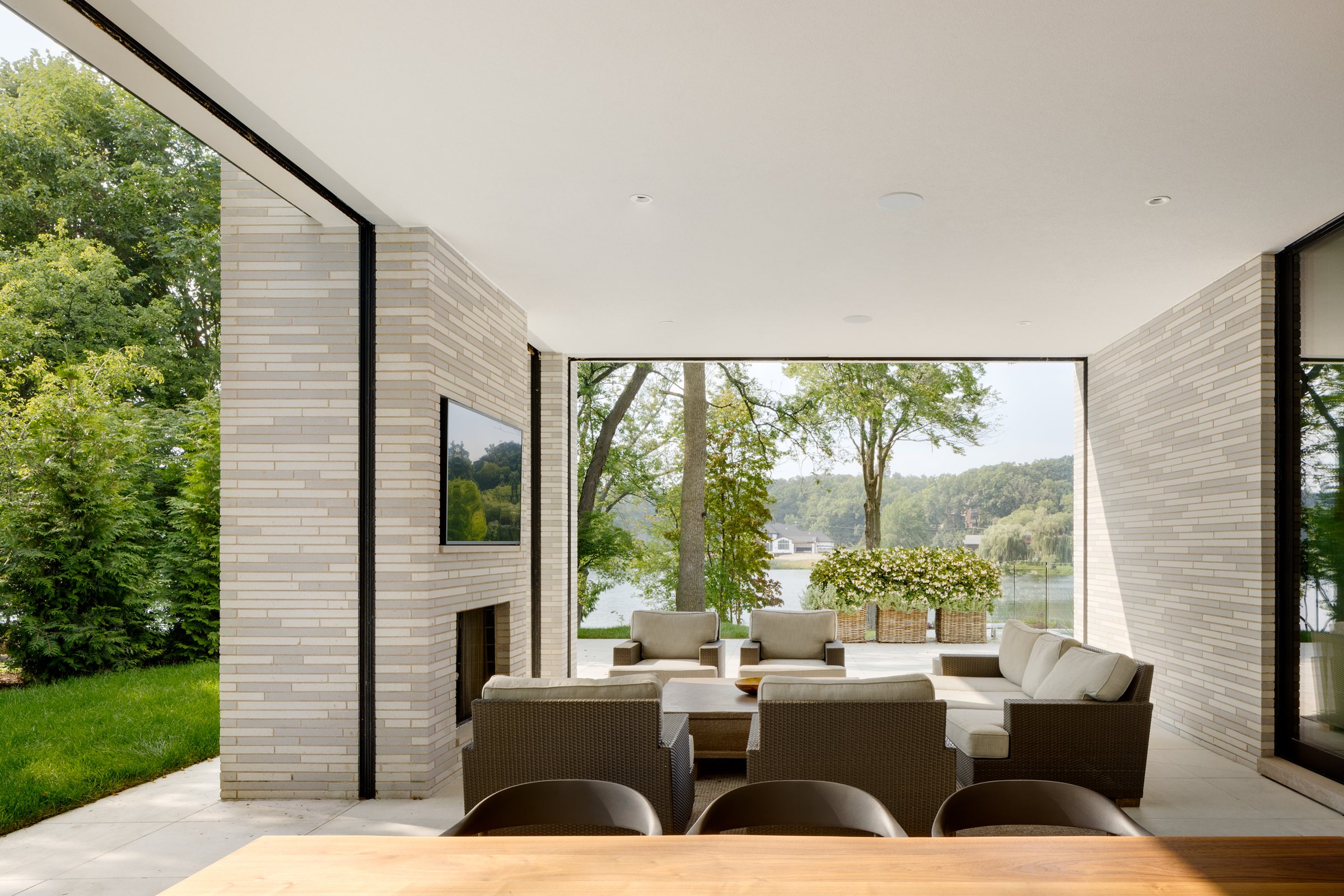 Covered terrace with a fireplace, open to the lake