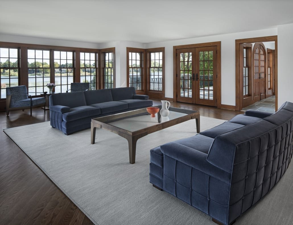 Living room with a wall of French doors to the lake